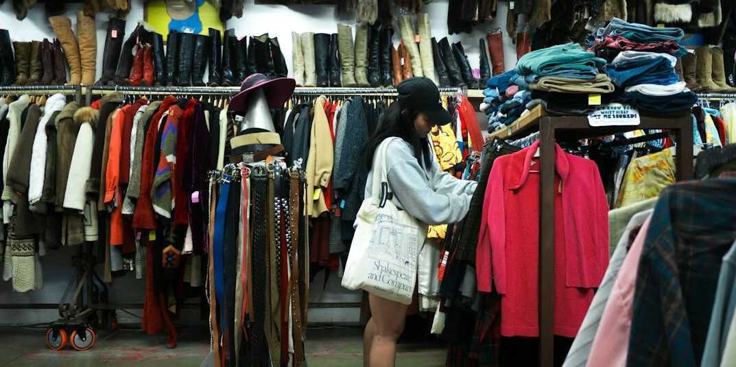 detective watching shoplifter in clothing store