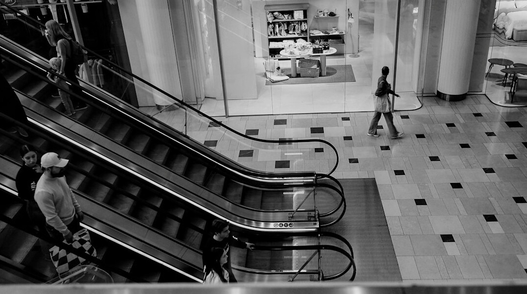 detective following suspect in mall